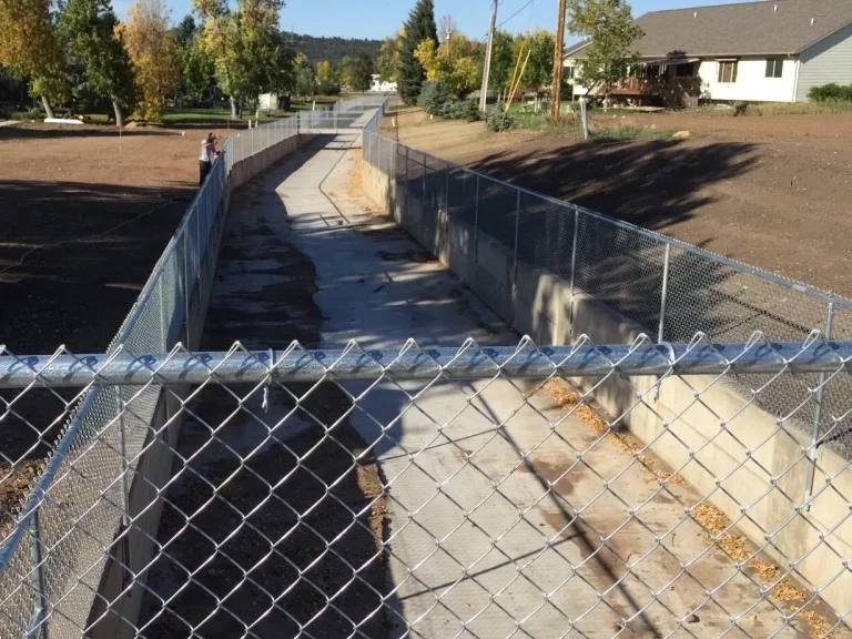 Commercial chain link fence around a flood control channel